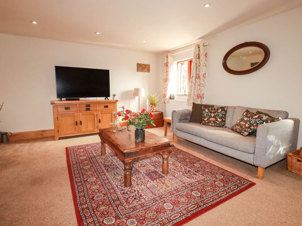 A living room with a sofa and coffee table at Skylark in Liskeard