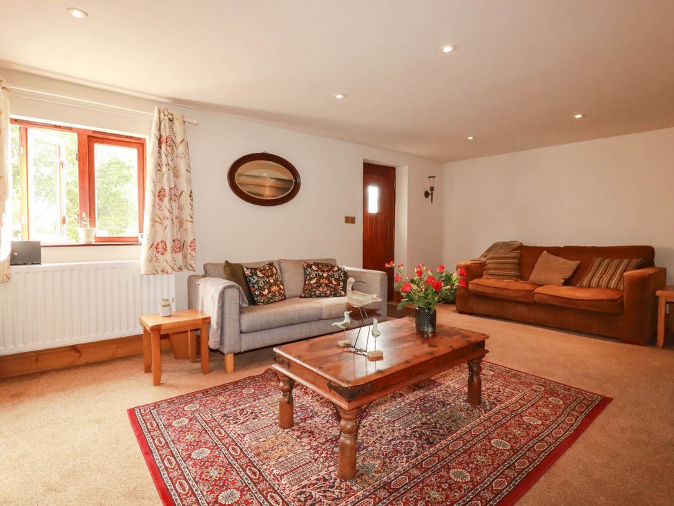 A living room with a sofa and coffee table at Skylark, Liskeard