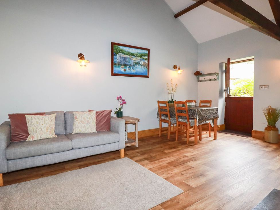 A dining room with a sofa and table at Skylark in Liskeard