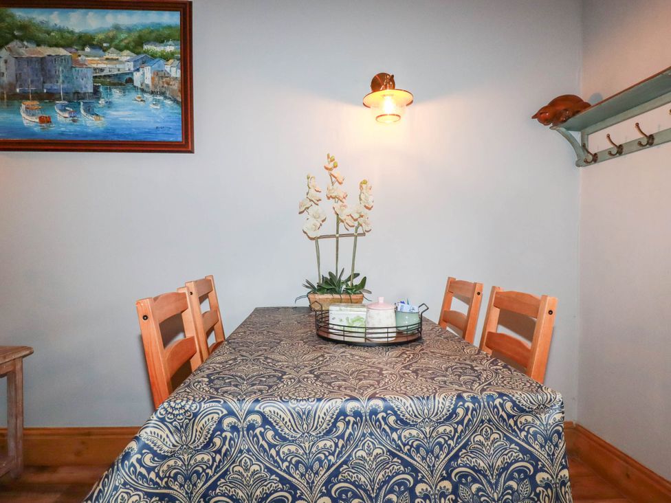 A dining room with a table and chairs at Skylark in Liskeard