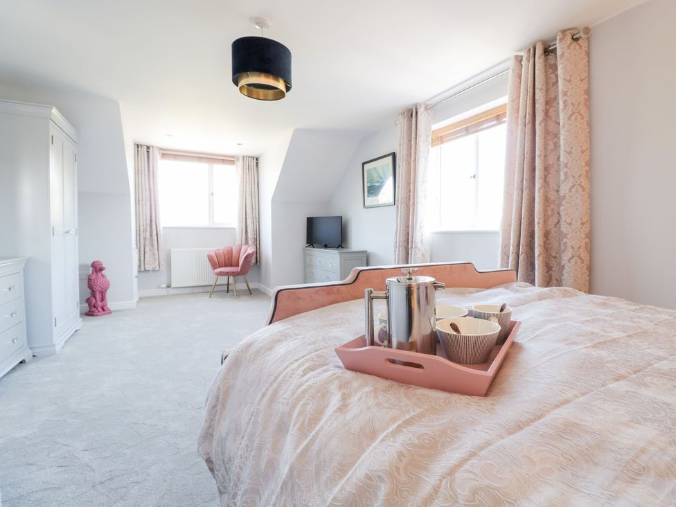 A bedroom with a bed and tea tray on it at Ger Y Mor in Cemaes Bay