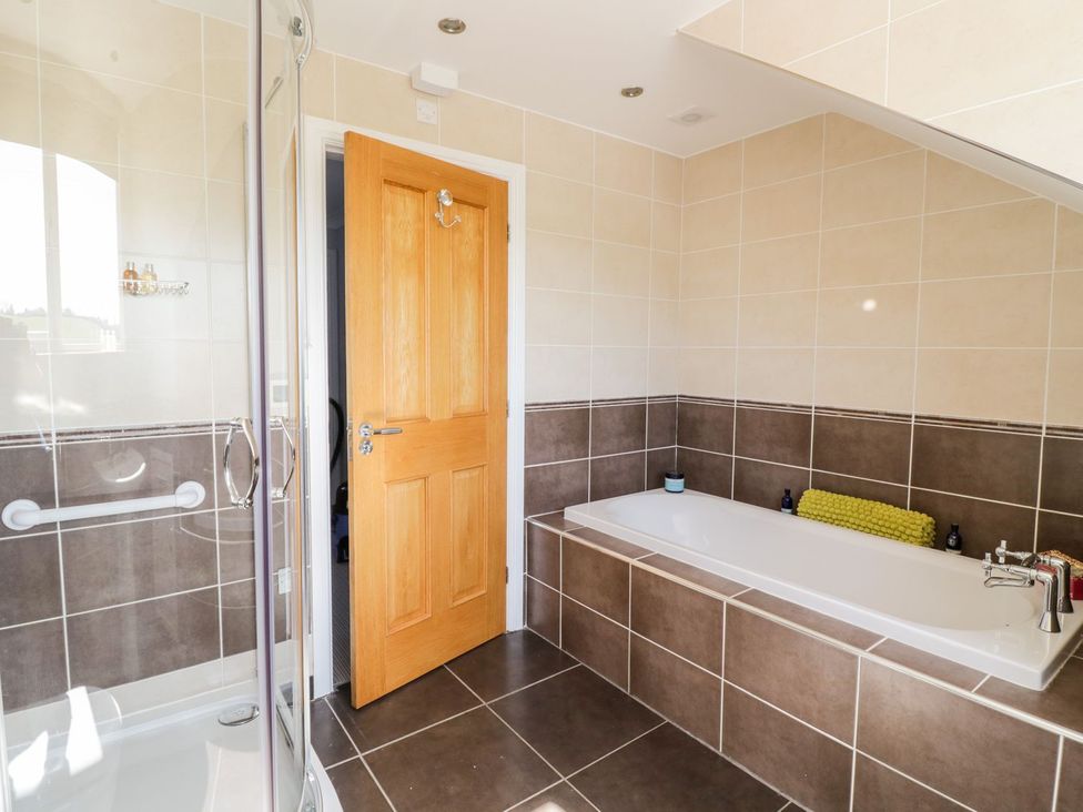 A bathroom with a bathtub and shower at Ger Y Mor in Cemaes Bay