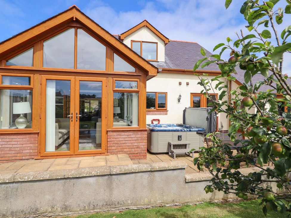 A conservatory with a hot tub at Ger Y Mor in Cemaes Bay