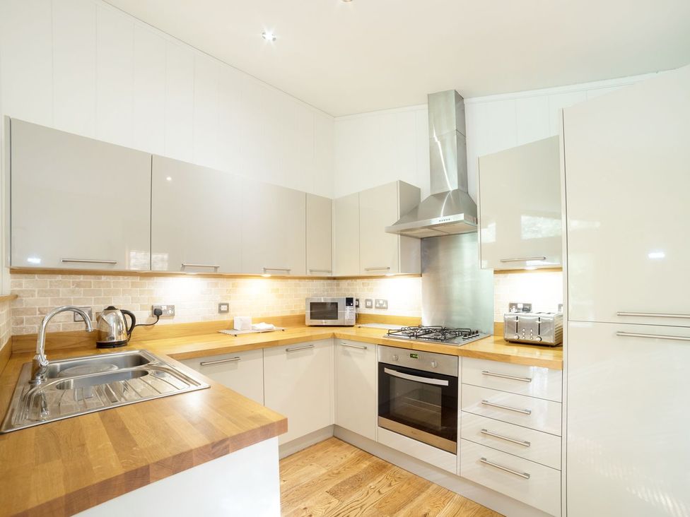 A kitchen with appliances and cabinets at 5 Tree Tops in Liskeard