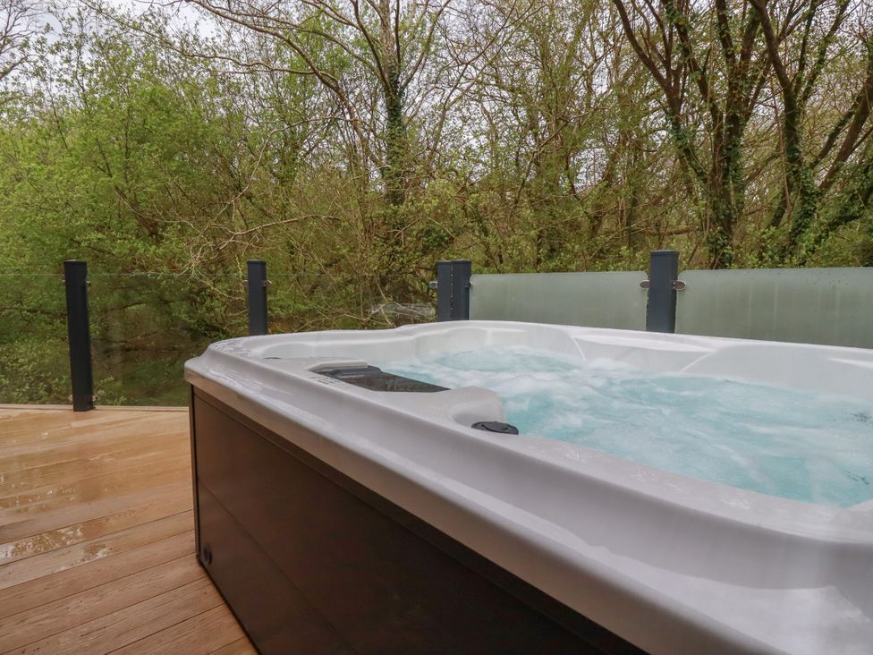 A hot tub on a wooden deck at 5 Tree Tops in Liskeard