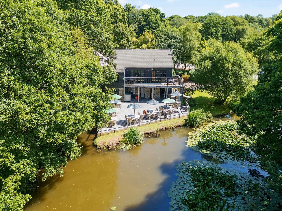 A building with a deck near water at 5 Tree Tops in Dobwalls