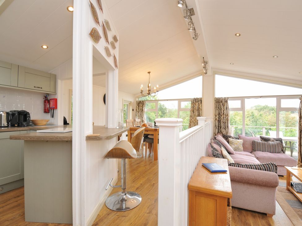 A living room and kitchen with dining area at 5 Tree Tops in Dobwalls