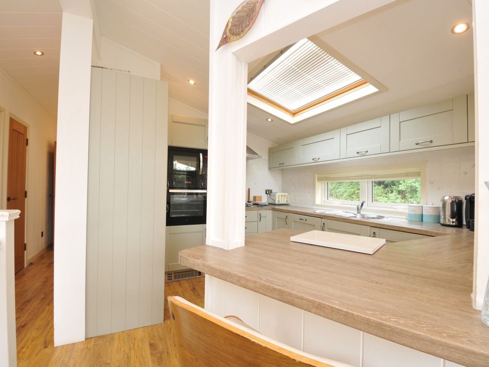 A kitchen with a skylight and modern appliances at 5 Tree Tops in Dobwalls