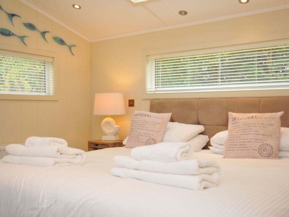 A bedroom with a bed and pillows at 5 Tree Tops in Dobwalls