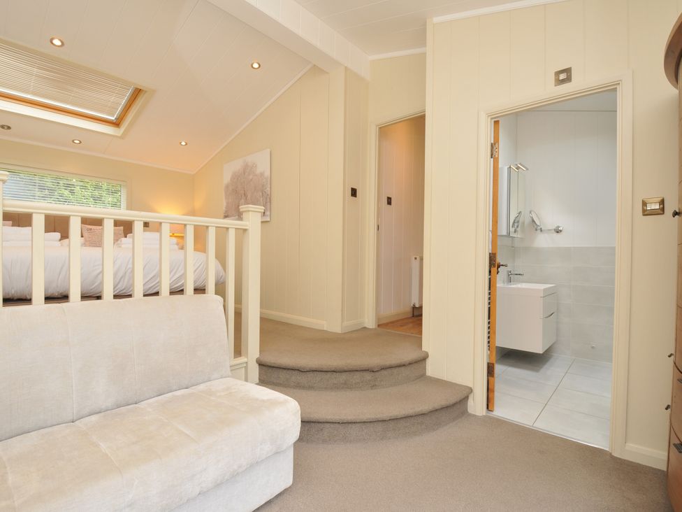 A bedroom with a bed and a bathroom entrance at 5 Tree Tops in Dobwalls