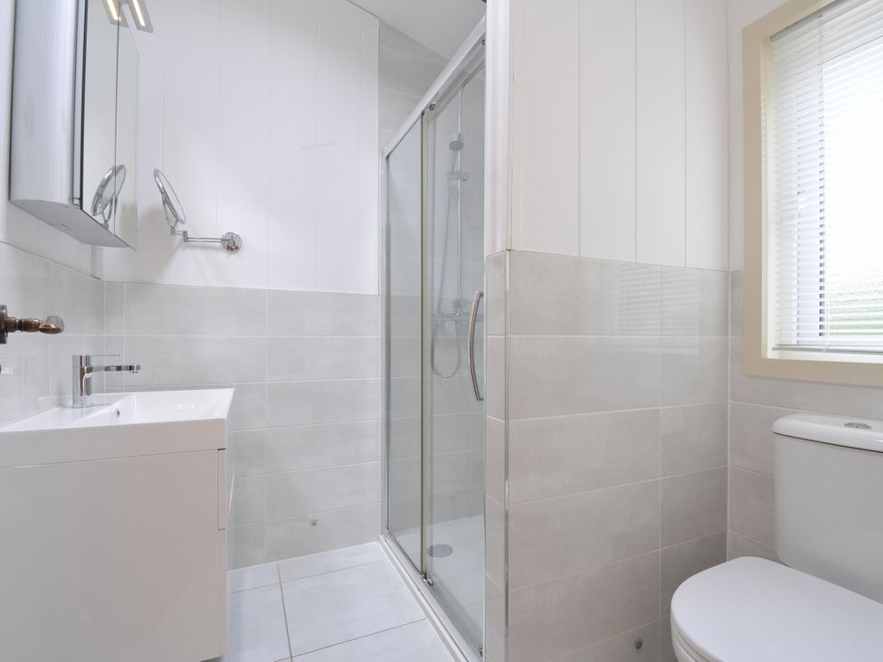 A bathroom with a shower, sink, and toilet at 5 Tree Tops in Dobwalls