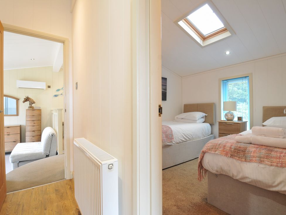 A bedroom with two beds and a chest of drawers at 5 Tree Tops in Dobwalls