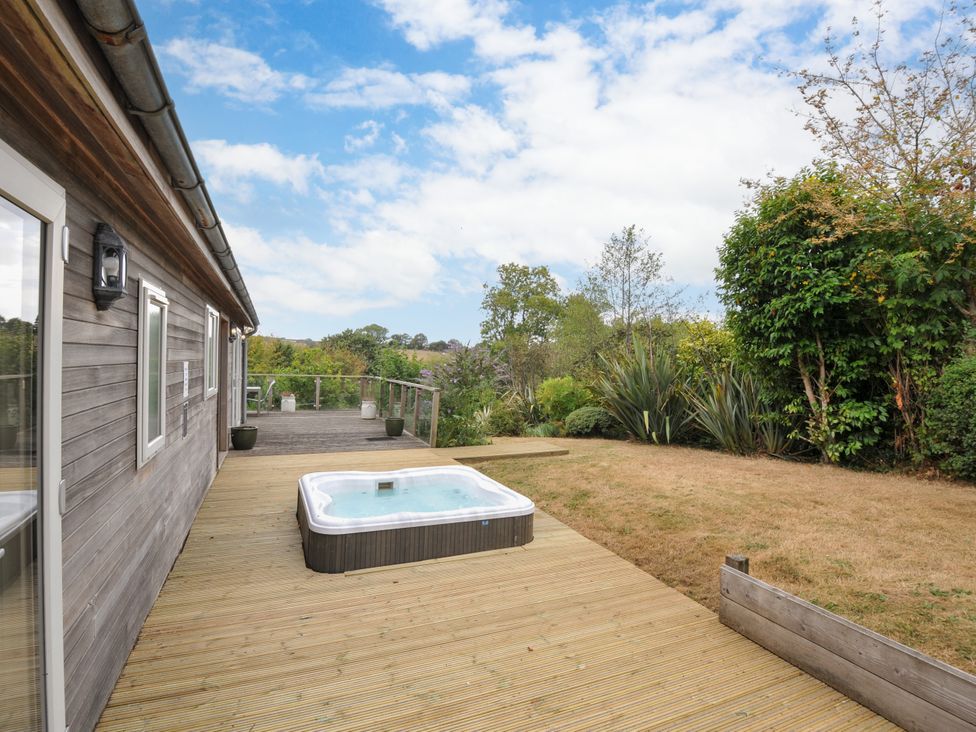 An outdoor area with a hot tub and decking at 5 Tree Tops, Dobwalls
