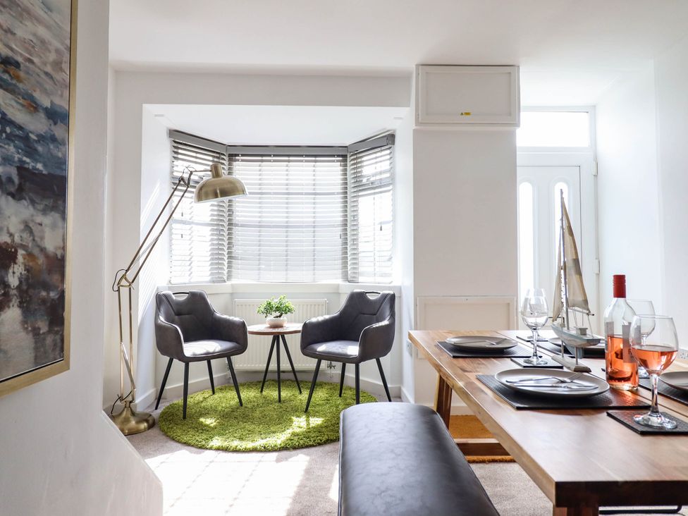 A dining room with a table and chairs at 1 Glanaber Terrace 
