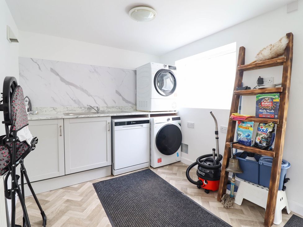 A laundry room with appliances and storage at 1 Glanaber Terrace