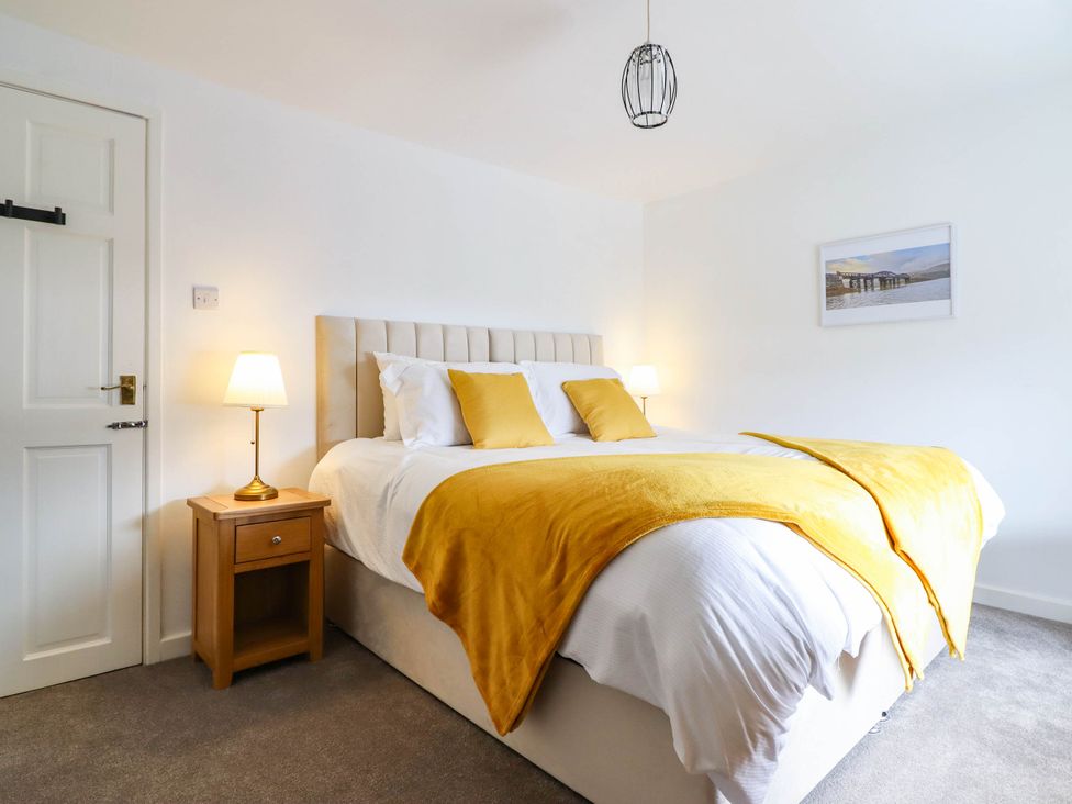 A bedroom with a bed and nightstand at 1 Glanaber Terrace