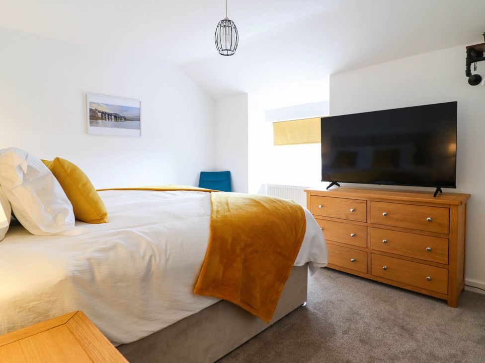 A bedroom with a bed and television at 1 Glanaber Terrace