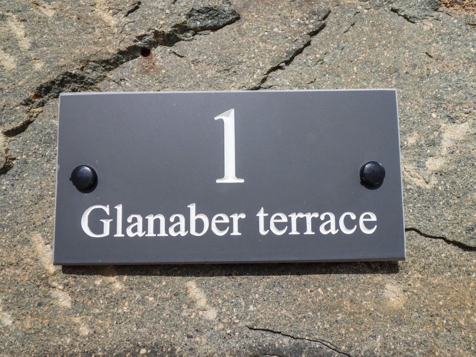 A sign displaying the house number 1 and Glanaber terrace at 1 Glanaber Terrace
