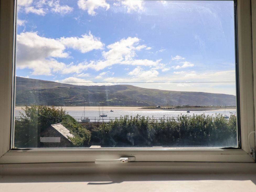 A view through a window showing water and boats at 1 Glanaber Terrace
