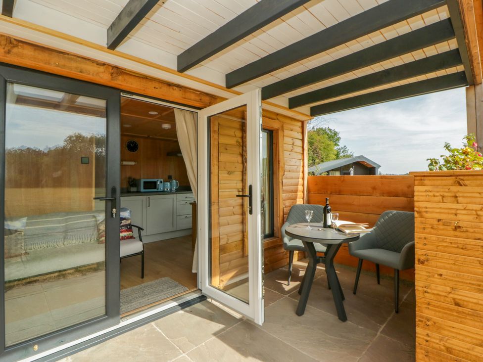 An outdoor area with a table and chairs at Oak Lodge Brecon