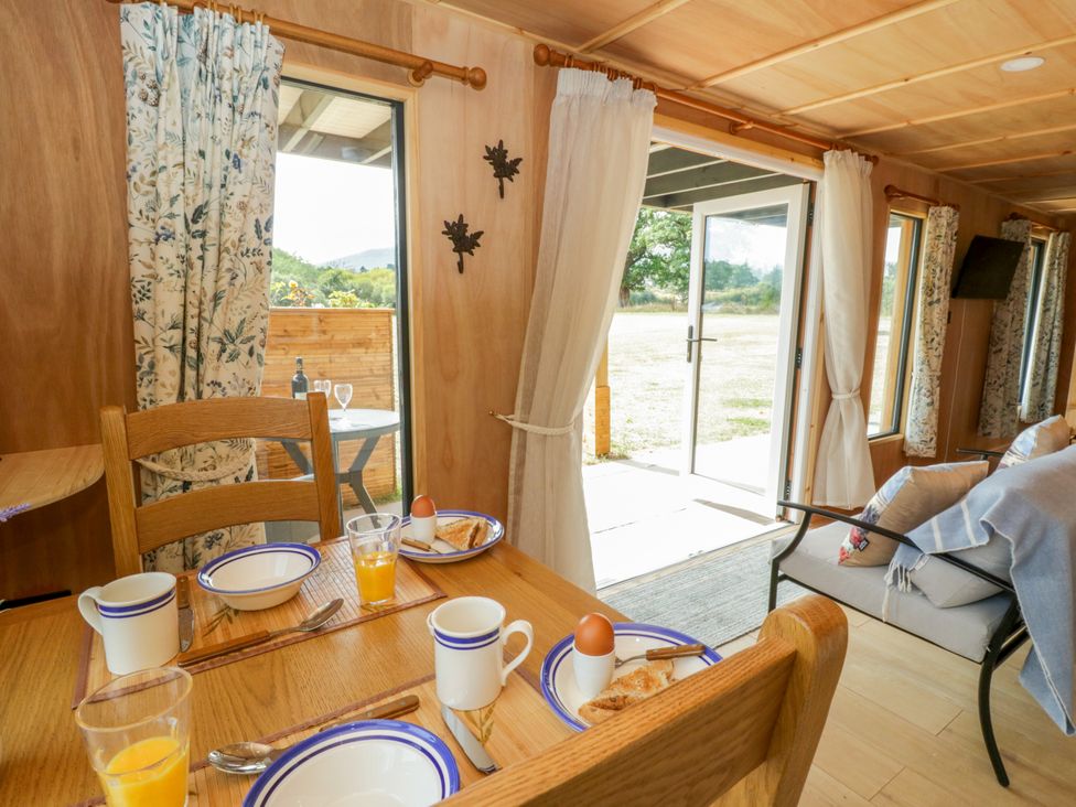 A dining room with breakfast on a table at Oak Lodge in Brecon