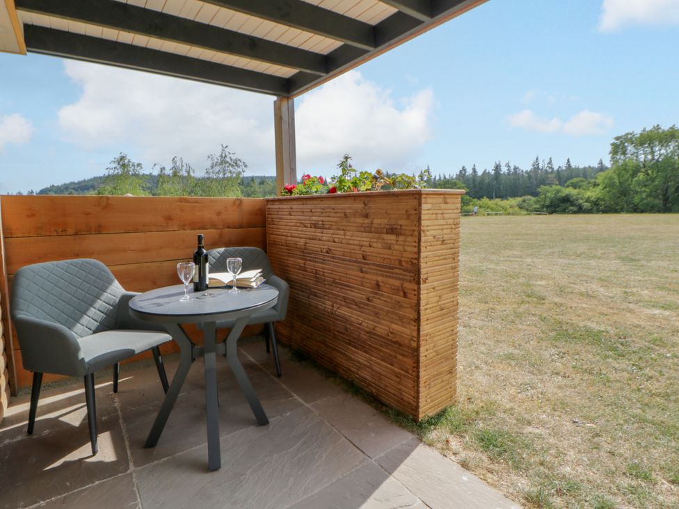 A table and chairs on a patio area at Oak Lodge Brecon