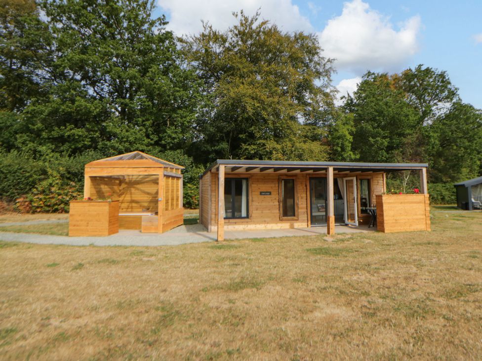 A house with a deck and outdoor seating at Oak Lodge Brecon