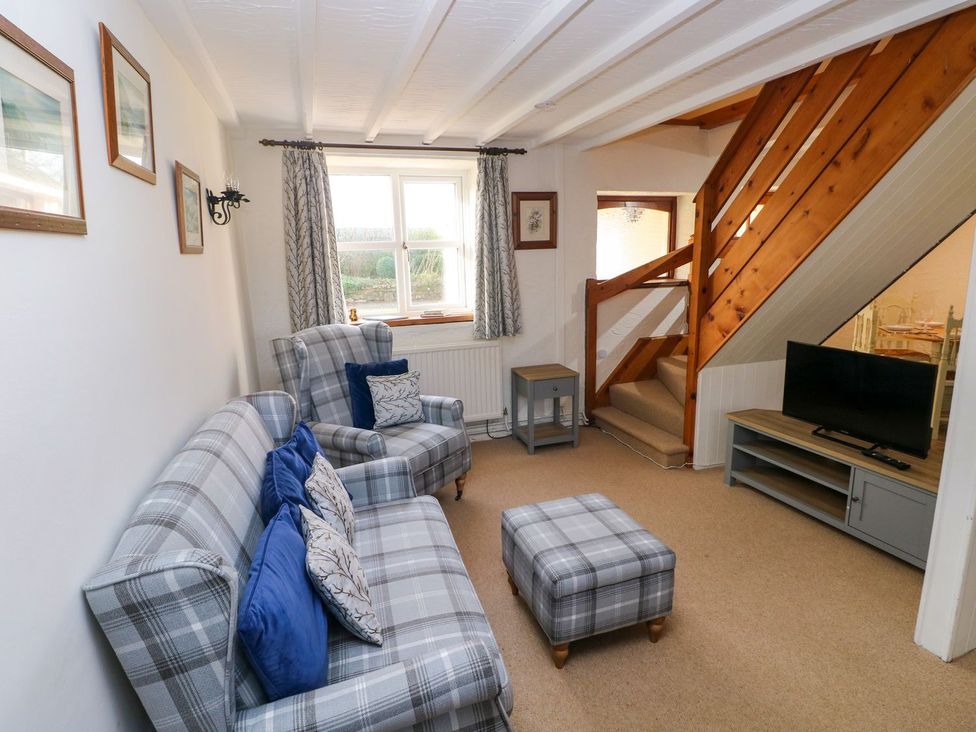 A living room with seating and a television at The Stable in Haverfordwest