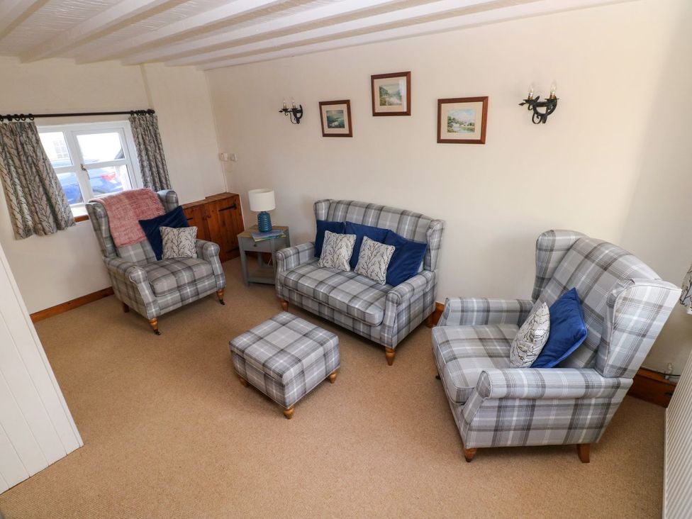 A living room with sofas and an ottoman at The Stable in Haverfordwest