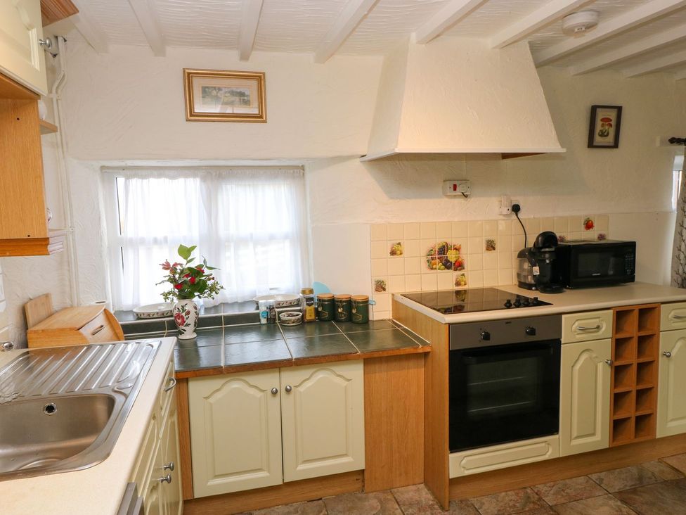 A kitchen with cabinets, counter, sink, and a window at The Stable in Haverfordwest
