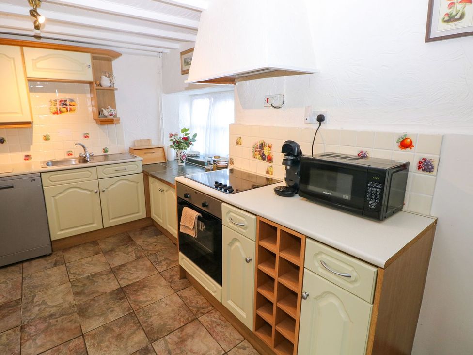 A kitchen with sink, oven, and microwave at The Stable in Haverfordwest
