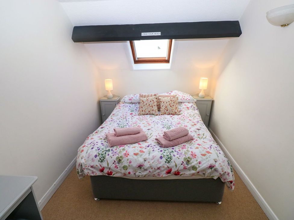 A bedroom with a bed and bedside tables at The Stable in Haverfordwest