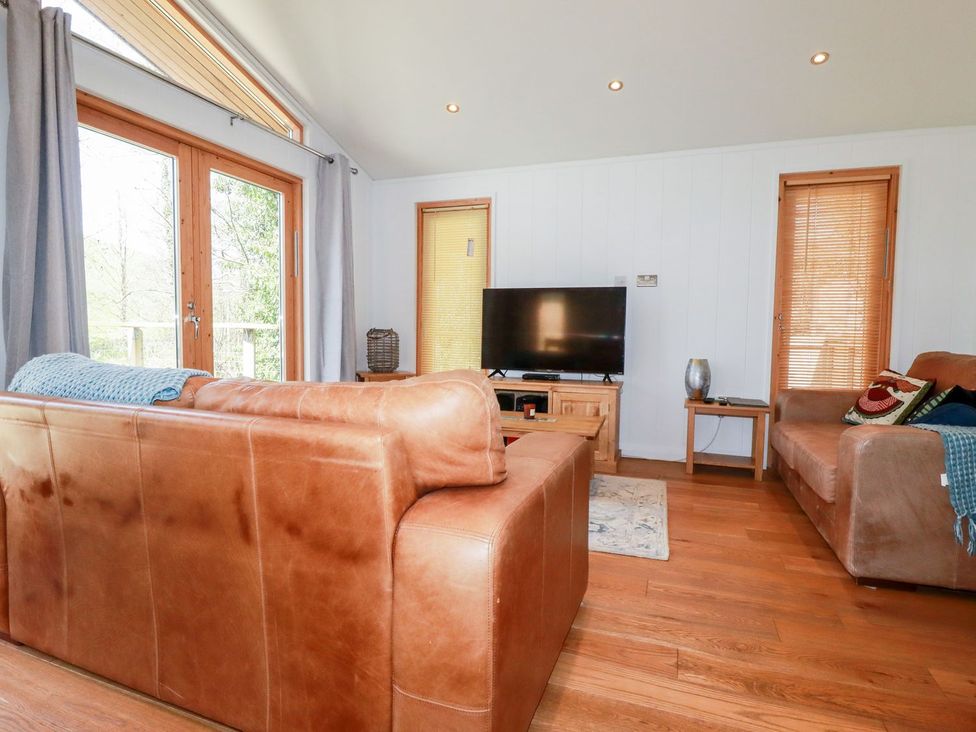 A living room with a sofa and television at 7 Stonerush Valley Looe