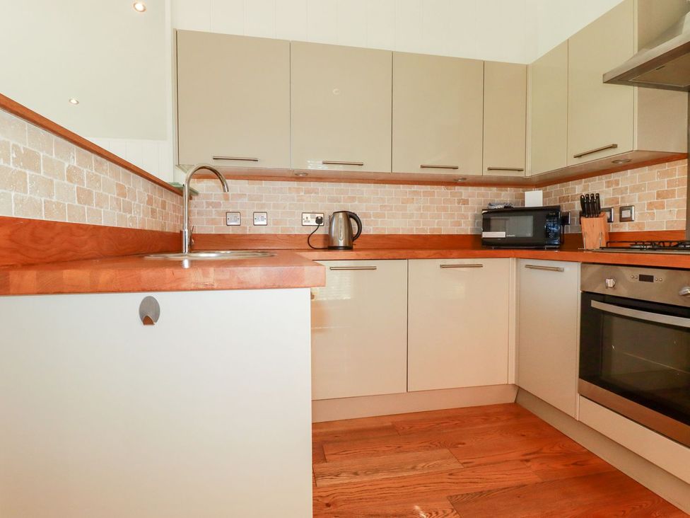 A kitchen with cabinets and appliances at 7 Stonerush Valley Looe