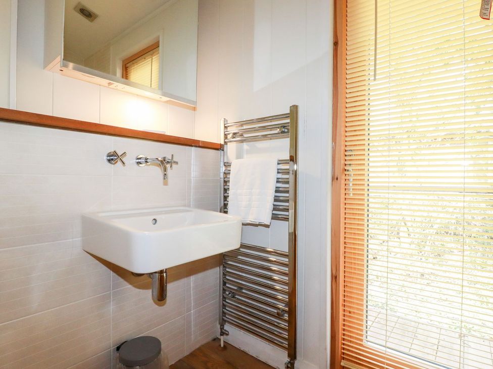 A bathroom with a hand wash basin and towel radiator at 7 Stonerush Valley Looe