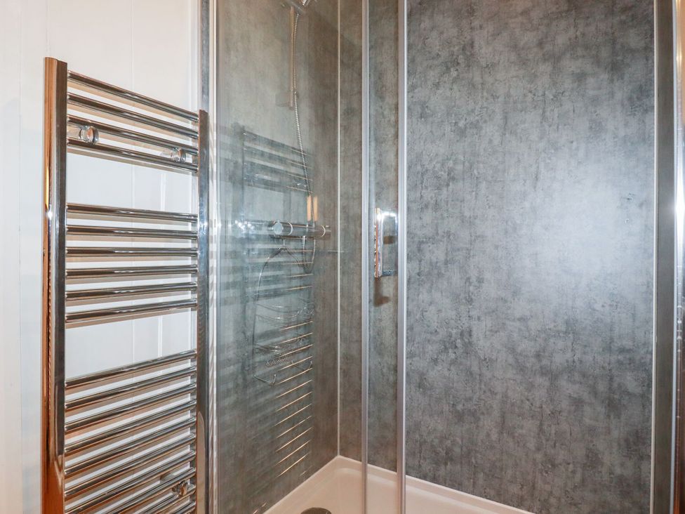 A shower with a towel warmer and a drain at 7 Stonerush Valley Looe