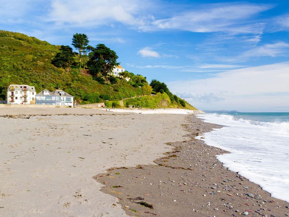 A beach with shoreline and buildings at 7 Stonerush Valley in Lanreath