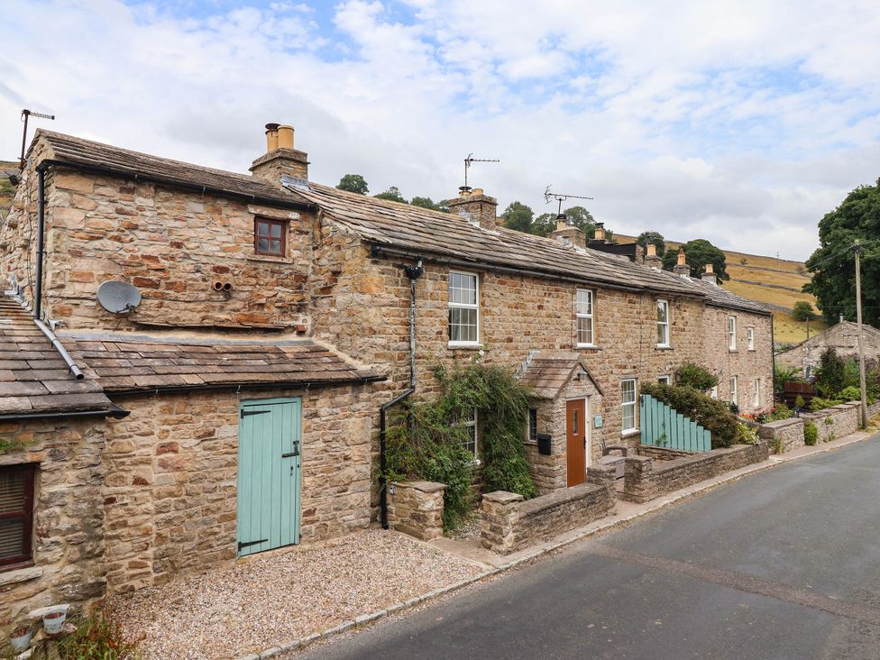 A stone house with a garden and pathway at South View in Richmond