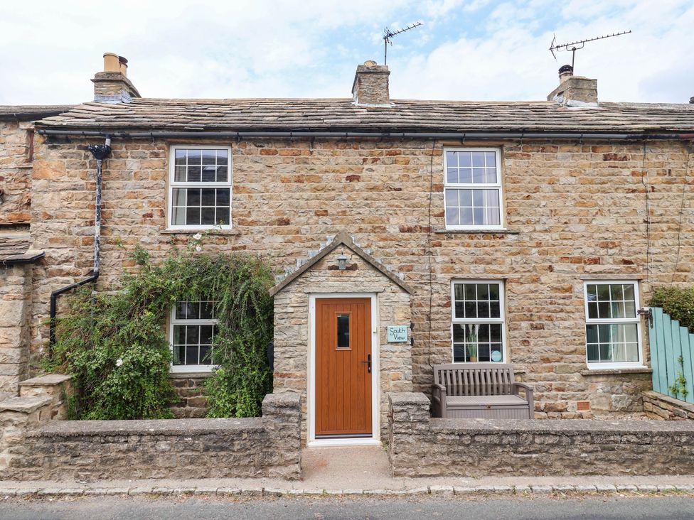 A house with stone exterior and a wooden door at South View in Richmond