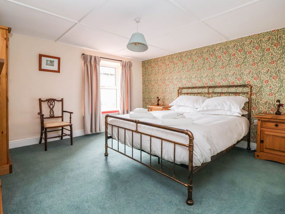A bedroom with a bed and chair at South View in Richmond