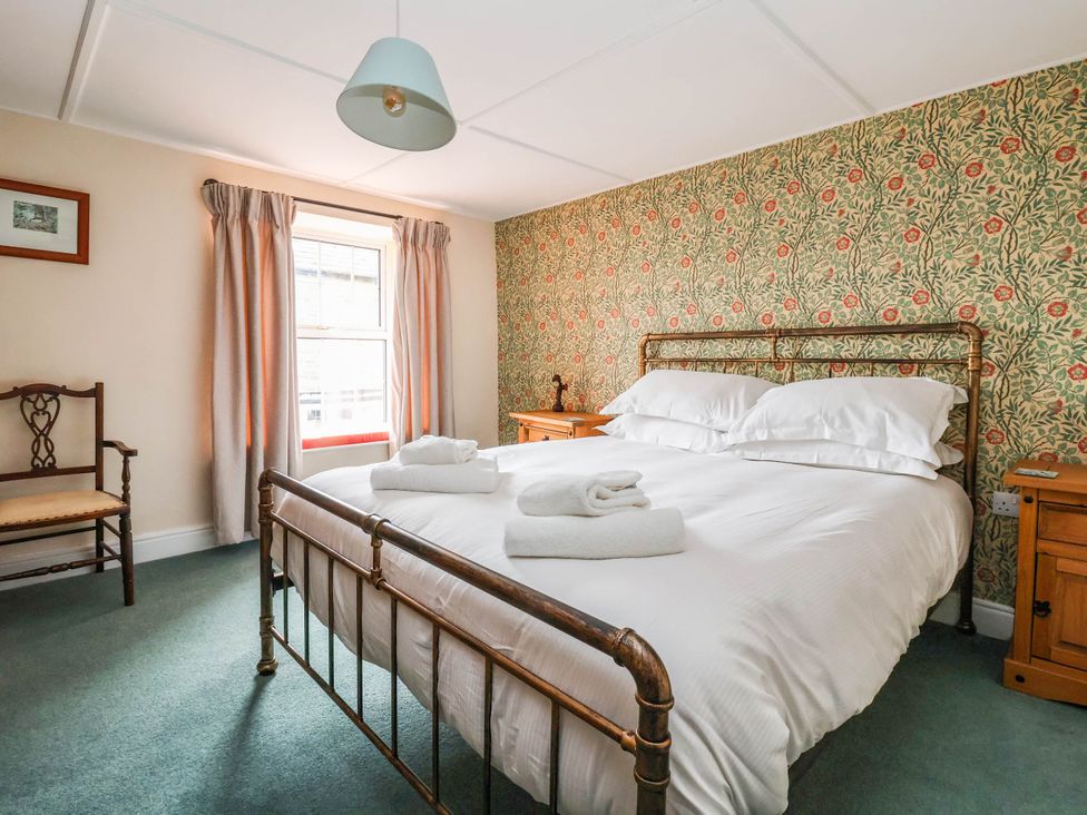 A bedroom with a bed and chair at South View in Richmond