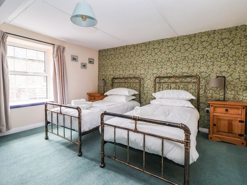 A bedroom with two beds and a nightstand at South View in Richmond
