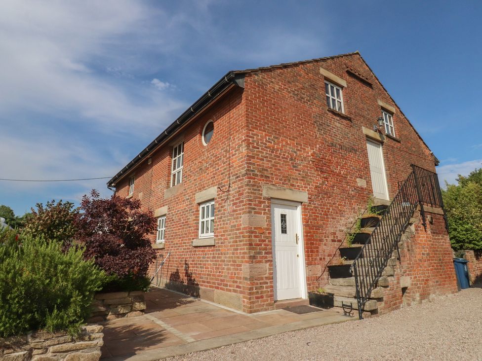 An exterior view of a brick building with stairs at The Shippon in Ormskirk