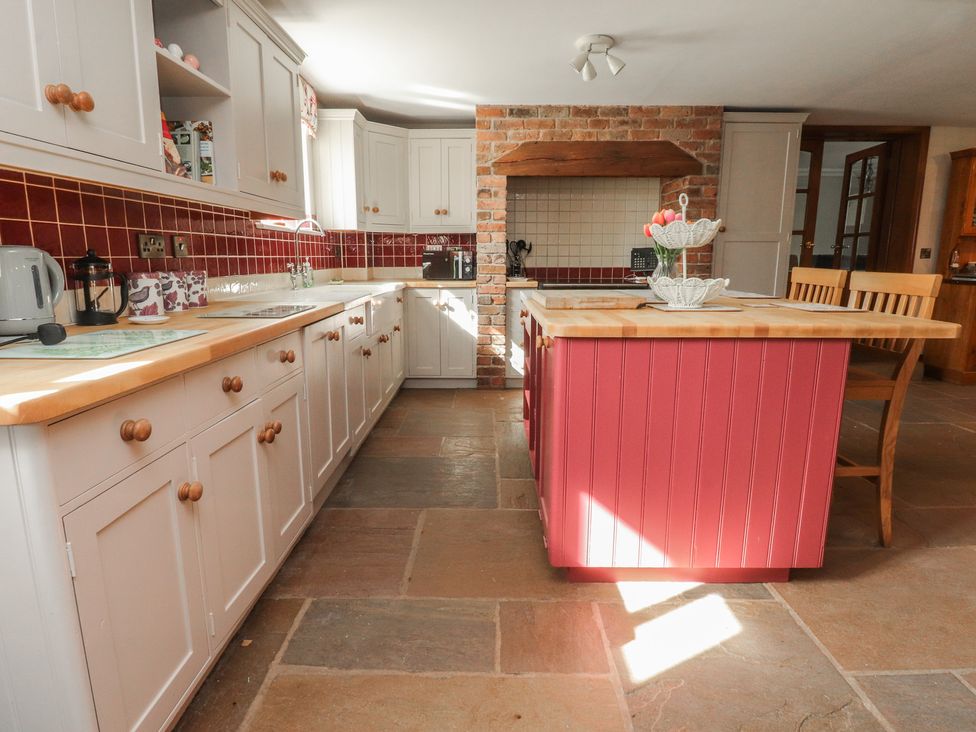 A kitchen with cabinets and a kitchen island at The Shippon in Ormskirk