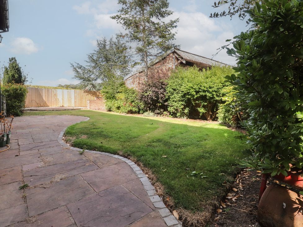 A garden with grass and a pathway at The Shippon in Ormskirk