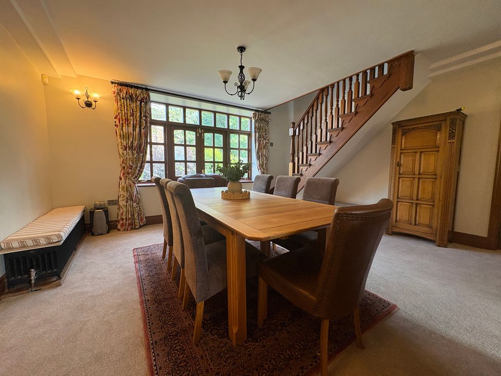 A dining room with a table and chairs at The Shippon in Burscough