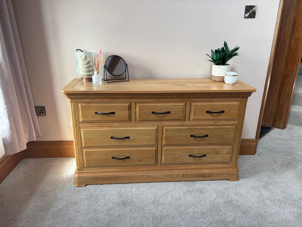 A dresser with a mirror and decorative items at The Shippon in Burscough