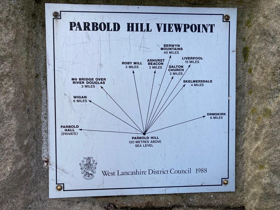 A directional sign at Parbold Hill with distances to various locations at The Shippon in Burscough
