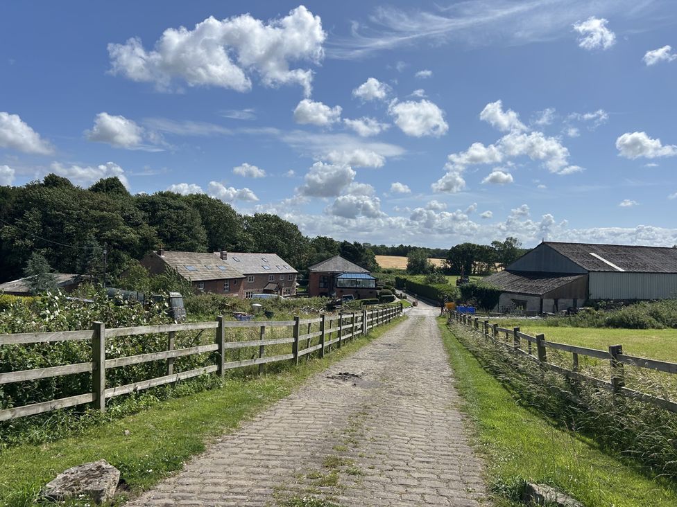 A road leading towards farm buildings at The Shippon in Burscough