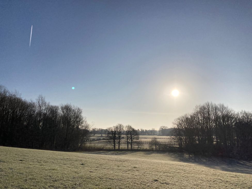 A landscape with trees and sun in the sky at The Log Cabin in Ormskirk